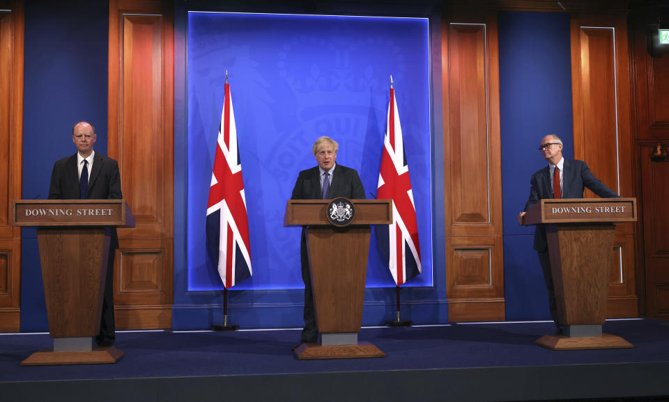 From left, Chief Medical Officer Professor Chris Whitty, Prime Minister Boris Johnson and Chief scientific adviser Sir Patrick Vallance attend a media briefing in Downing Street, London, Monday, June 14, 2021. Johnson has confirmed that the next planned relaxation of coronavirus restrictions in England will be delayed by four weeks until July 19 as a result of the spread of the delta variant. In a press briefing Monday, Johnson said he is “confident that we won’t need more than four weeks” as millions more people get fully vaccinated against the virus, which could save thousands of lives. (Jonathan Buckmaster/Pool Photo via AP)