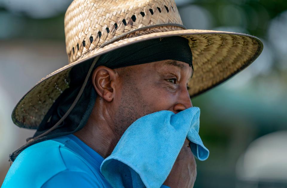 City worker Glen Peterson wipes the sweat from his face as the feel like temperature exceeded 100 degrees while working with a crew on June 28, 2023 in Lake Worth Beach, Florida.