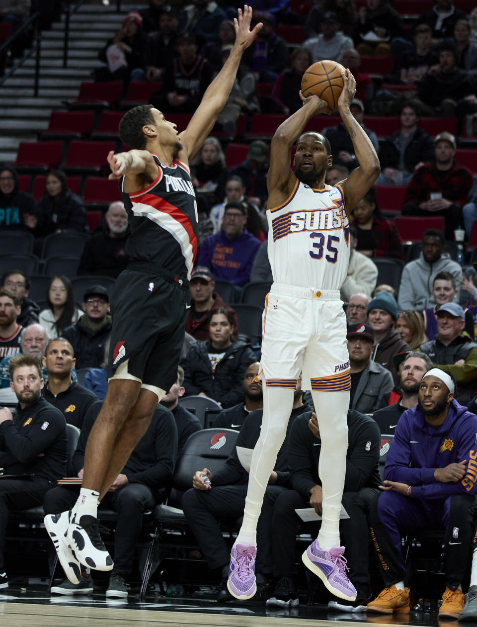 Phoenix Suns forward Kevin Durant, right, looks to shoot over Portland Trail Blazers forward Kris Murray, left, during the first half of an NBA basketball game in Portland, Ore., Sunday, Jan. 14, 2024. (AP Photo/Craig Mitchelldyer)