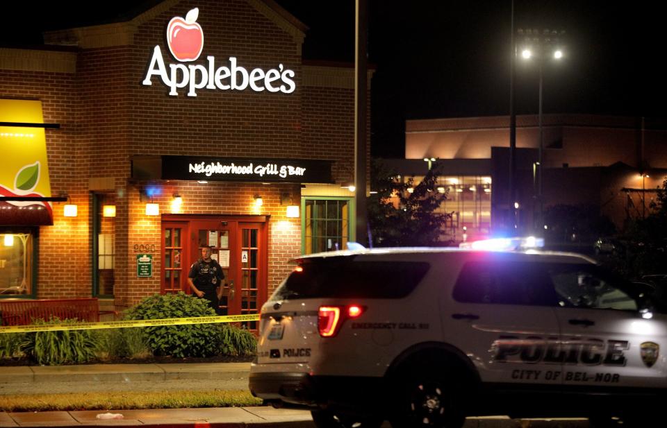 FILE - In this June 22, 2020, file photo, a police offer stands posted at the entrance of an Applebee's restaurant, in St. John, Mo., a suburb of St. Louis. A gunman opened fire inside the restaurant, killing one and injuring at least two others, police said. A new study released Monday, Feb. 1, 2021, by the National Commission on COVID-19 and Criminal Justice and Arnold Ventures looked at 34 U.S. cities and found a 30% spike in killings in 2020 compared to 2019. The study said the coronavirus pandemic and the racial injustice protests that followed George Floyd's death were factors. (Christian Gooden/St. Louis Post-Dispatch via AP File)