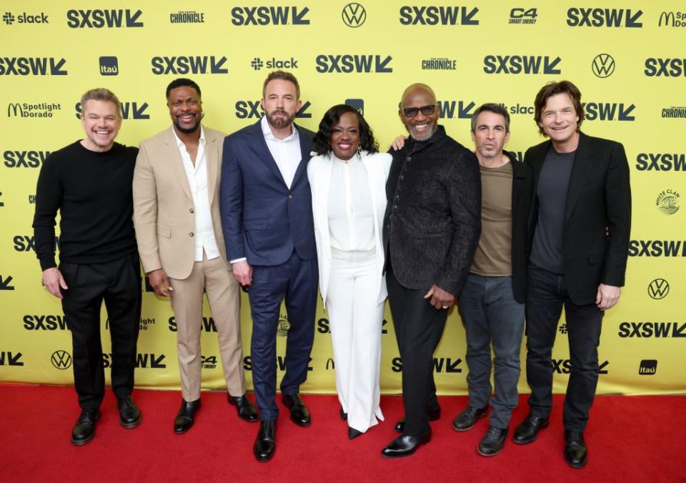 matt damon, chris tucker, ben affleck, viola davis, julius tennon, chris messina, and jason bateman pose for a photo on a red carpet in front of a sxsw yellow backdrop with black sxsw logos