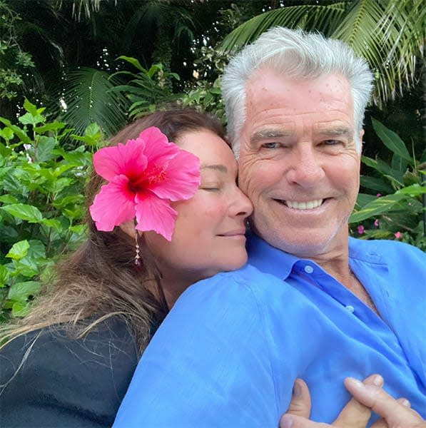 Keely hugging Pierce Brosnan from behind