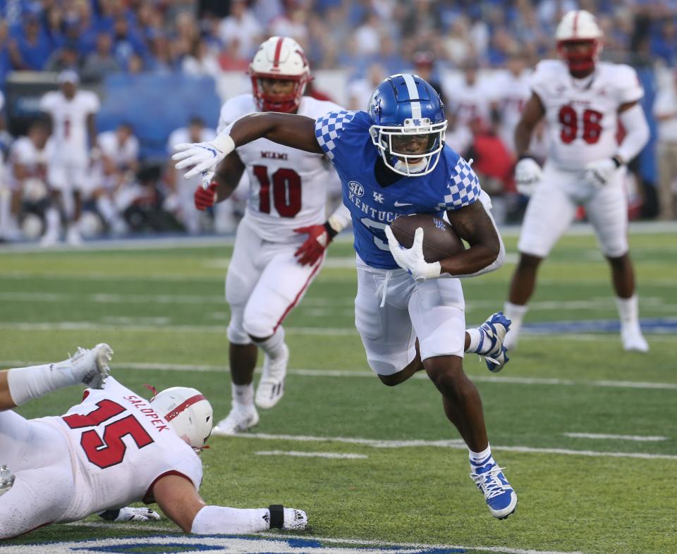 Kentucky’s Kavosiey Smoke gets as much out of this catch and runs he can against Miami of Ohio.Sept. 3, 2022