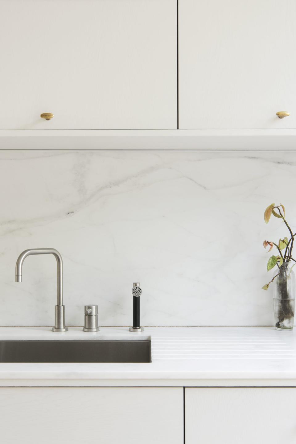 Look closely and you'll see a drain board etched right into the marble countertop. Set a few dripping dishes on top and the water will drain right into the sink, says Roberts. It's a simple customization you can request through your marble fabricator.