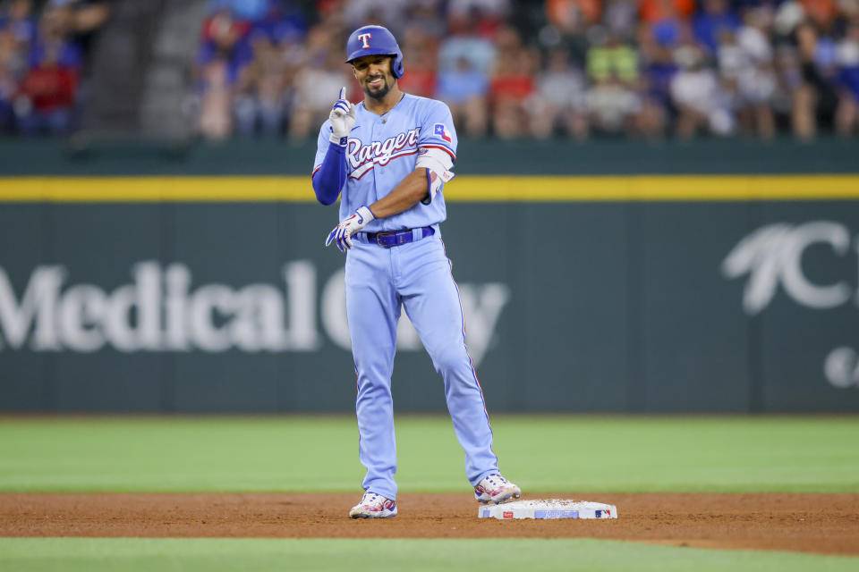 Texas Rangers' Marcus Semien celebrates after hitting a double in the fifth inning of a baseball game against the Houston Astros, Sunday, July 2, 2023, in Arlington, Texas. (AP Photo/Gareth Patterson)