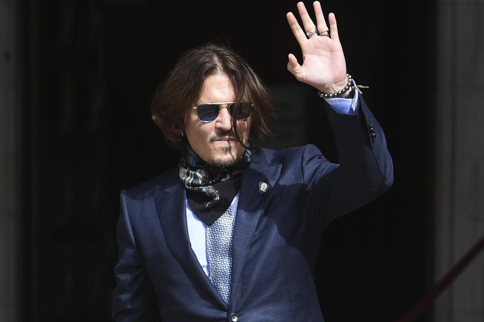 Actor Johnny Depp arrives at the High Court for a hearing in his libel case, in London, Friday, July 24, 2020. Depp is suing News Group Newspapers, publisher of The Sun, and the paper's executive editor, Dan Wootton, over an April 2018 article that called him a "wife-beater." The Sun's defense relies on a total of 14 allegations by his ex-wife, actress Amber Heard of Depp's violence. He strongly denies all of them. (Kirsty O'Connor/PA via AP)