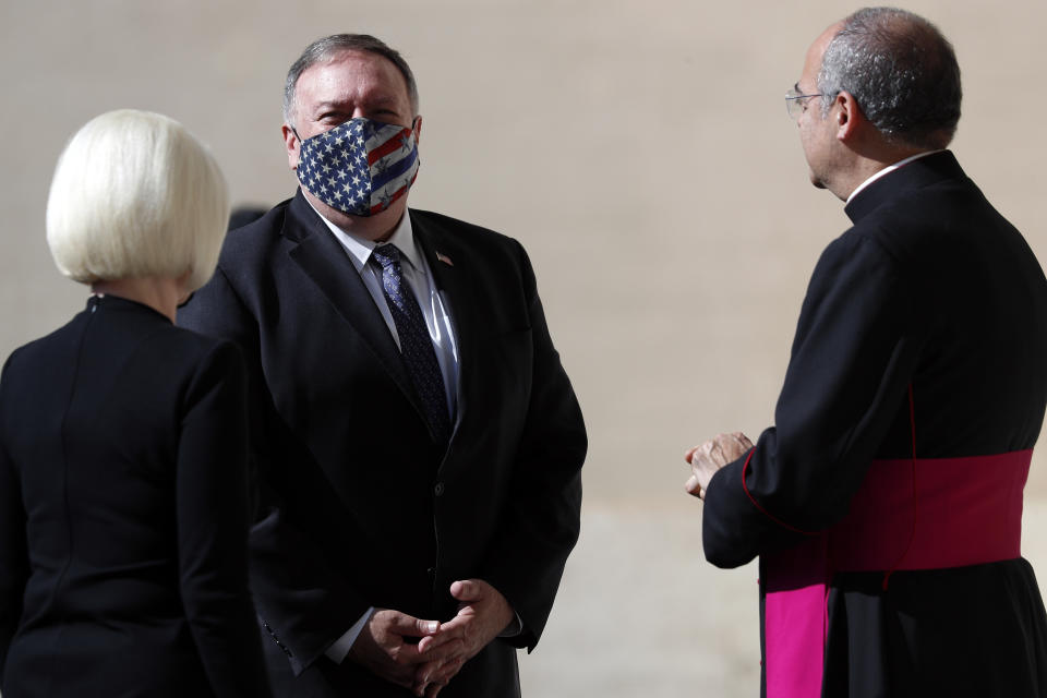 U.S. Secretary of State Mike Pompeo is welcomed by Monsignor Guillermo Karcher at the Vatican, Thursday, Oct. 1, 2020. Pompeo is meeting Thursday with top Vatican officials, a day after tensions over U.S. opposition to the Vatican's China policy spilled out in public. (AP Photo/Andrew Medichini)