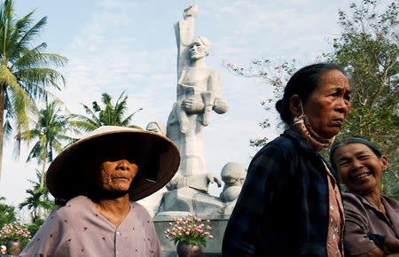 Vietnamese villagers attend the 50th anniversary of the My Lai massacre in My Lai village, Vietnam March 16, 2018. REUTERS/Kham