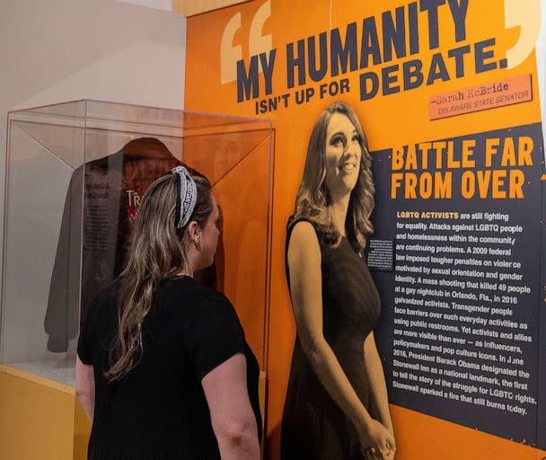 PHOTO: A person reads about Delaware Legislature Sarah McBride becoming the first transgender person to speak at a political convention, displayed in the Rise Up exhibition at the Dallas Holocaust and Human Rights Museum, on June 8, 2023, in Dallas. (Adam Davis/EPA via Shutterstock)