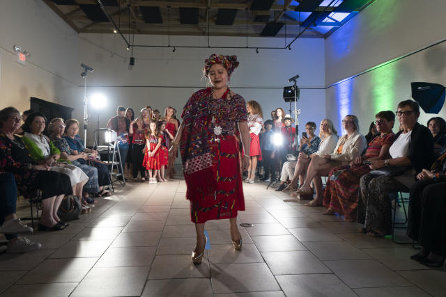 Guatemalan artist Elena de Leon walks the runway durning fashion show featuring her Guatemalan textiles, Friday, May 12, 2023, in Brownsville, Texas. A Guatemala-born designer combined indigenous weaving technique, modern clothing design and colorful history from her native country came together on a recent weekend on on a runway showcase. The fashion show offered a taste of not only Elena De León's artistic vision, but of the work by mothers living in the U.S. or back in their country to support their families. (AP Photo/Julio Cortez)