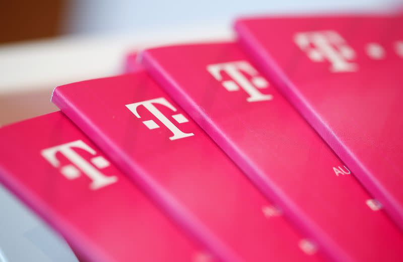 FILE PHOTO: Brochures with the logo of Deutsche Telekom AG are pictured at the shop in the headquarters of German telecommunications giant in Bonn