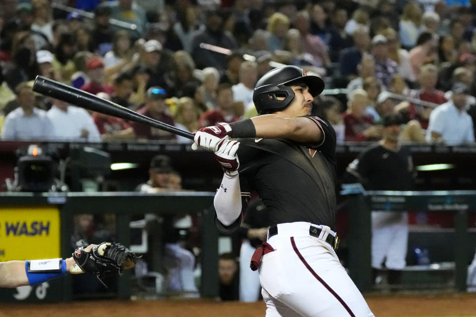 Arizona Diamondbacks' Josh Rojas watches his RBI double against the Los Angeles Dodgers during the sixth inning of a baseball game Thursday, April 6, 2023, in Phoenix. (AP Photo/Ross D. Franklin)