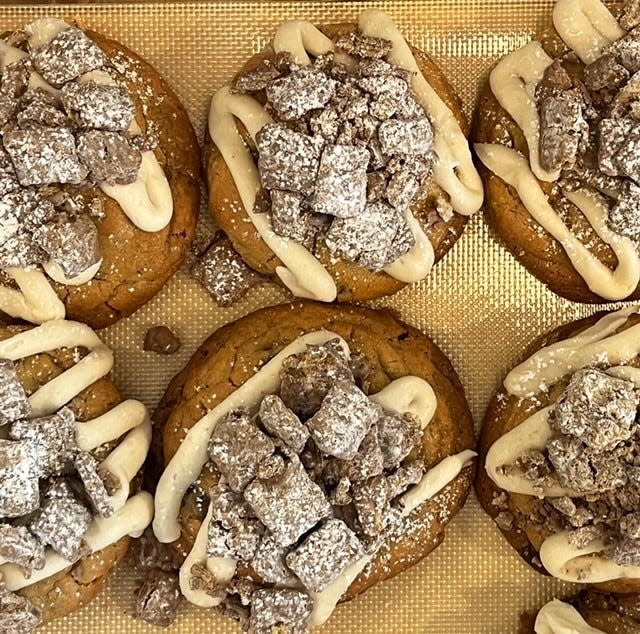 Lion Cub's Cookies' Puppy Chow is a peanut-butter cookie with chocolate chips that's frosted and topped with Puppy Chow snack mix.