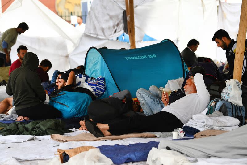 Refugees wait outside at the main reception centre for asylum seekers, in Ter Apel