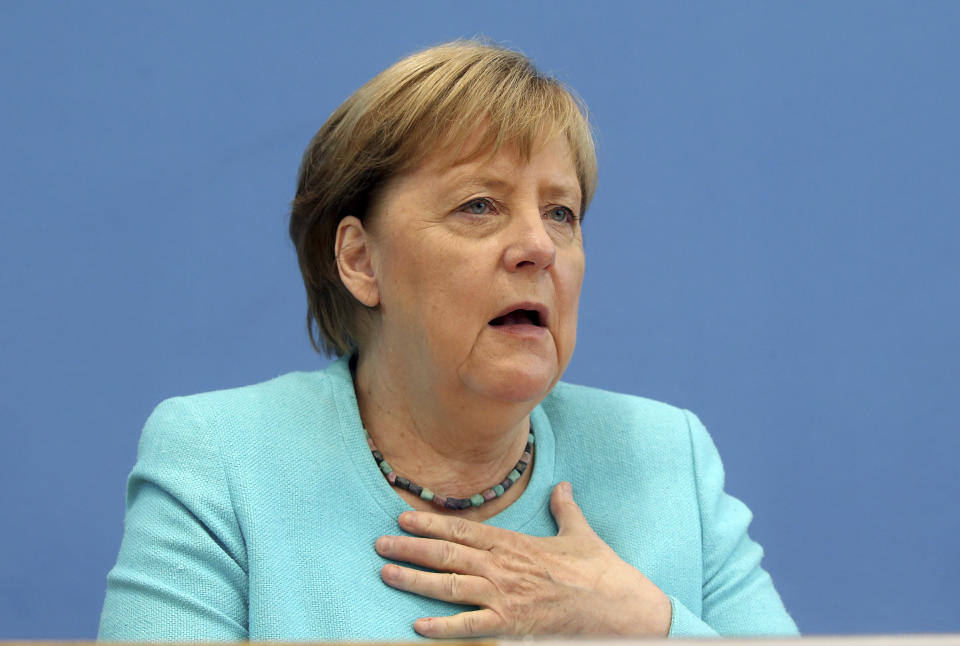 German Chancellor Angela Merkel, gestures, as she holds her annual summer news conference in Berlin, Germany, Thursday, July 22, 2021. Merkel said Thursday that new coronavirus infections in Germany are once again rising at worrying speed. She appealed to her compatriots to get vaccinated and persuade others to do so. (Wolfgang Kumm/dpa via AP)