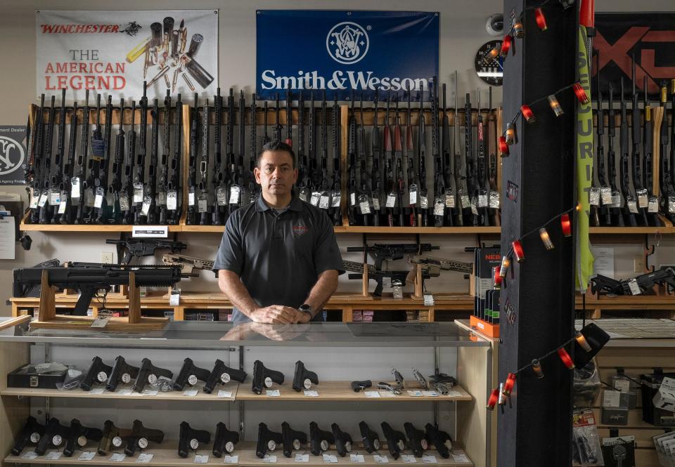 Oct 24, 2023; columbus, ohio, usa; Eric Delbert, Owner of L.E.P.D. Firearms, Range & Training Facility stands behind a display in his store on Bethel Road.