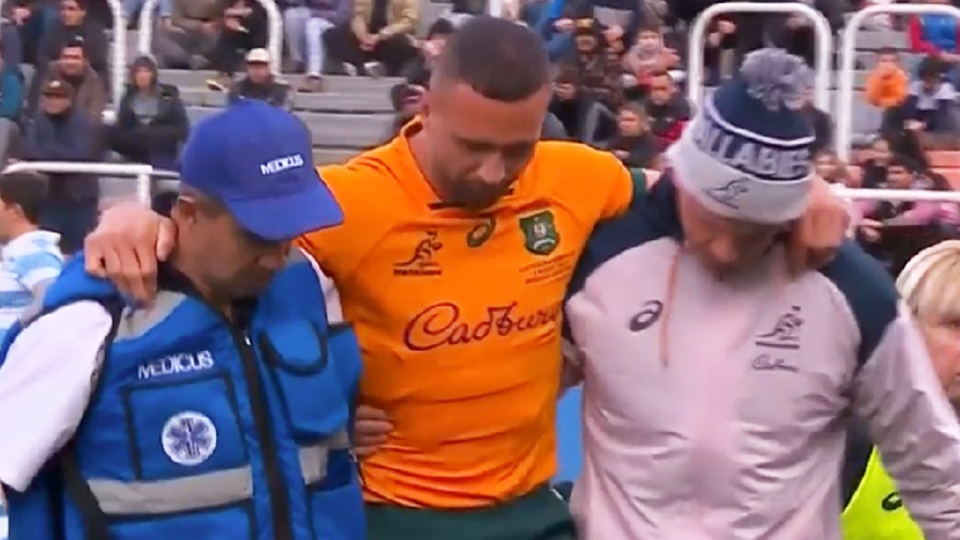 Quade Cooper (pictured) being helped off the field after hurting his leg.