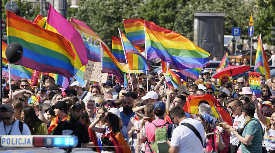 People take part in the Equality Parade, the largest gay pride parade in central and eastern Europe, in Warsaw, Poland, Saturday June 19, 2021. The event has returned this year after a pandemic-induced break last year and amid a backlash in Poland and Hungary against LGBT rights.(AP Photo/Czarek Sokolowski)