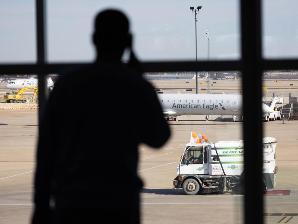 A passenger awaits his flight at Dallas-Fort Worth International Airport (DFW) in Dallas, Texas.