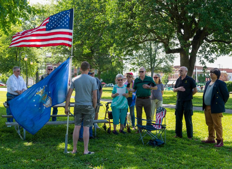 Gabe Whitley, far right, gathers with people to exercise their First Amendment rights as Brenda Bergwitz, center, reads “I Am the Flag“ by Howard Schnauber at Westside Library Park Saturday, May 30, 2020.