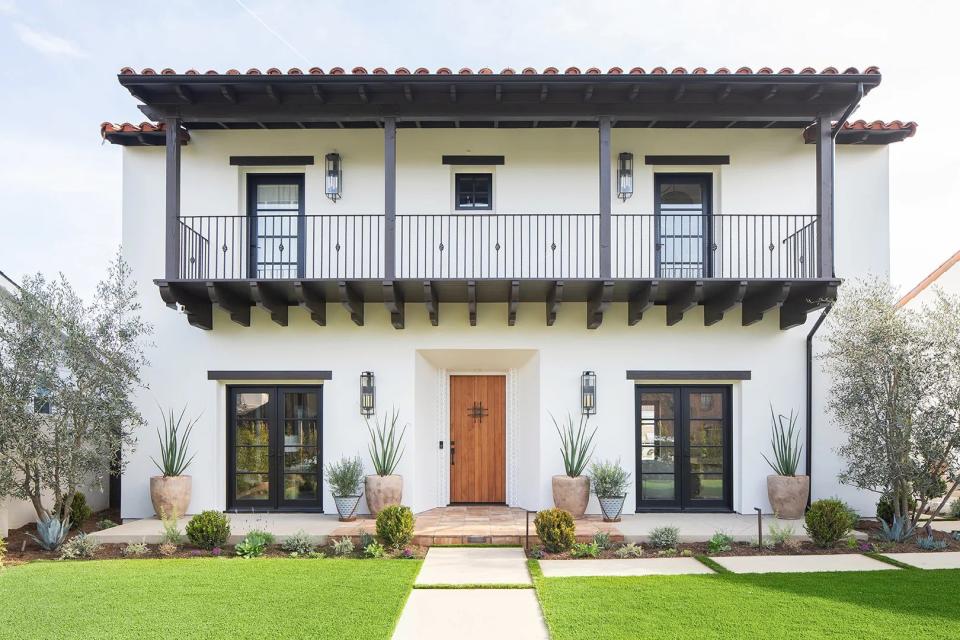 white house with dark wood balcony