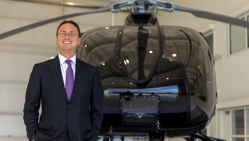 Brandon Fugal stands in his hangar in front of his custom Airbus H130 helicopter in Provo on Thursday, July 21, 2022.