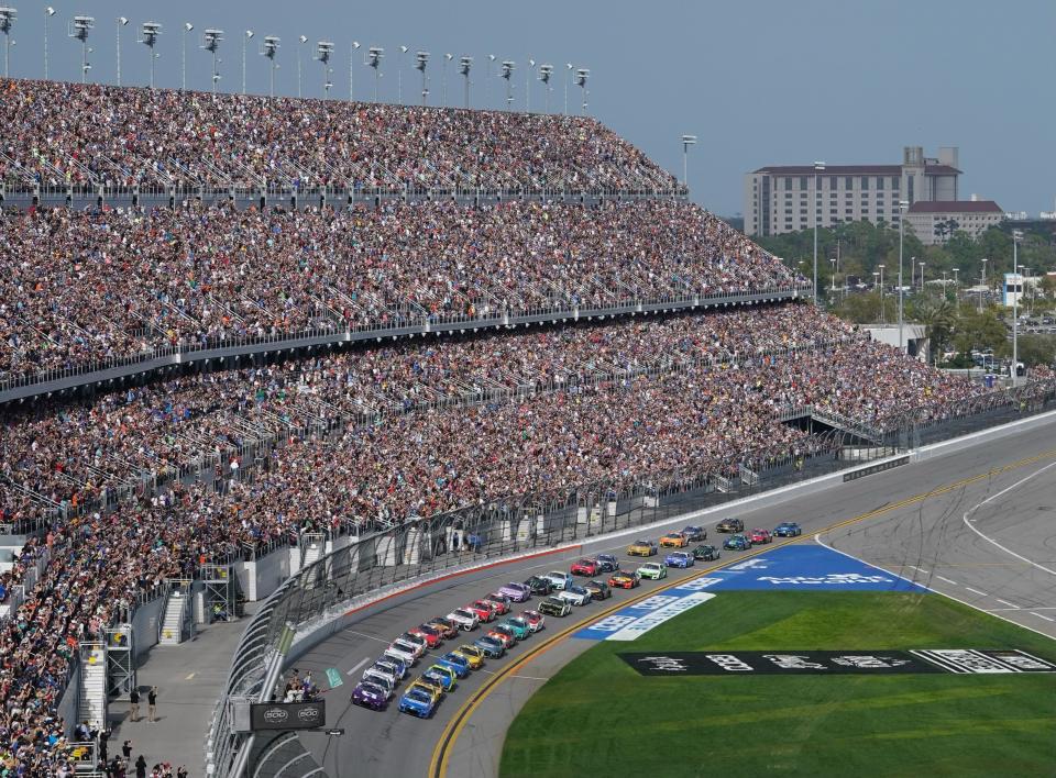 Alex Bowman (48) and Kyle Larson (5) bring the field to the green flag to start the 65th Daytona 500 on Sunday.