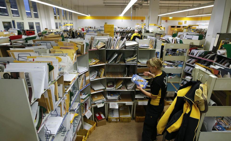 Postwoman Standke of Deutsche Post sorts mail in Berlin