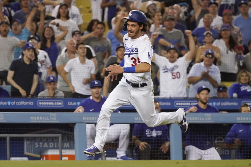 Los Angeles Dodgers' Cody Bellinger rounds third base to score on a double by AJ Pollock during the fourth inning of the team's baseball game against the San Francisco Giants on Wednesday, July 21, 2021, in Los Angeles. (AP Photo/Marcio Jose Sanchez)