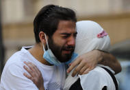 Relatives of Ibrahim Harb, 35, who was critically injured in the massive explosion at Beirut's port last year and who died on Monday nearly 14 months after the blast, mourn during his funeral procession in Beirut, Lebanon, Tuesday, Sept. 28, 2021. On Aug. 4, 2020, hundreds of tons of ammonium nitrate, a highly explosive material used in fertilizers, ignited after a massive fire at the port. The death brings to at least 215 the number of people who have been killed by the blast, according to official records. (AP Photo/Hussein Malla)