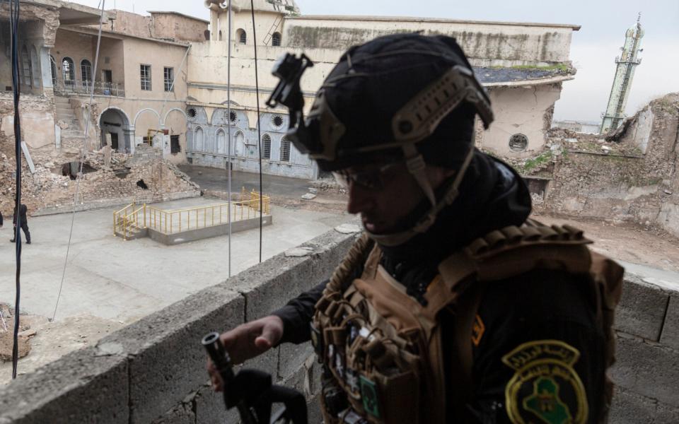  soldier stands guard over The Al Tahira Orthodox Church in the Old City of Mosul, Iraq, on March 4th, 2021. On March 6th,  - Sam Tarling for the Telegraph 