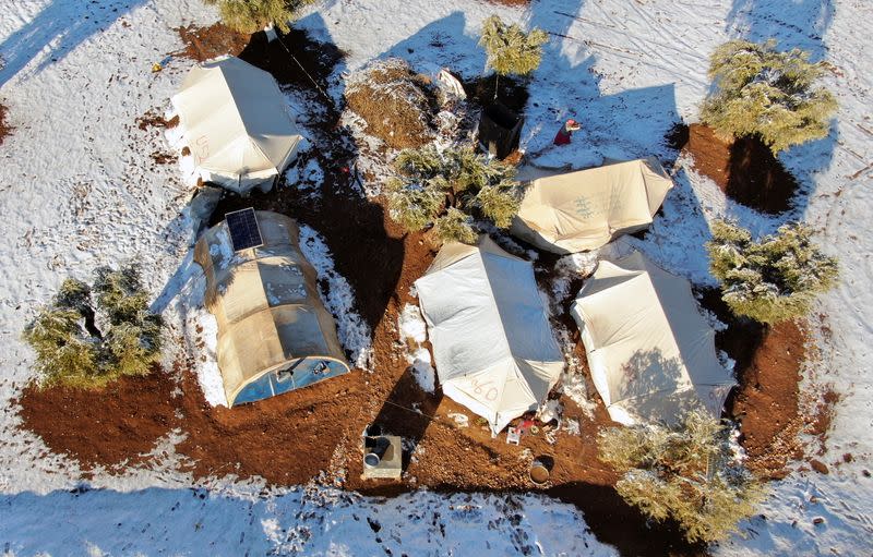 A general view shows tents partially covered in snow at a camp for internally displaced people, in northern Aleppo countryside