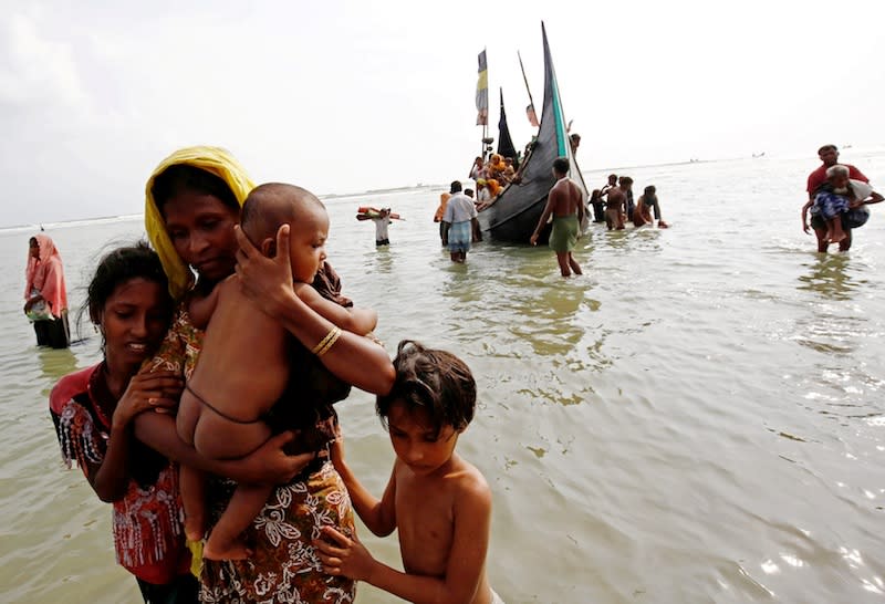 Rohingya refugee women and children walks to the shore after crossing the Bangladesh-Myanmar border by boat through the Bay of Bengal in Teknaf in this file picture taken on September 5, 2017. — Reuters pic