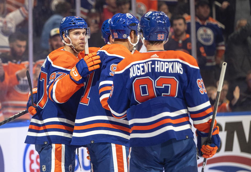 Edmonton Oilers' Connor McDavid (97), Evander Kane (91) and Ryan Nugent-Hopkins (93) celebrate a goal against the Calgary Flames during the second period of an NHL hockey game Saturday, Oct. 15, 2022, in Edmonton, Alberta. (Jason Franson/The Canadian Press via AP)