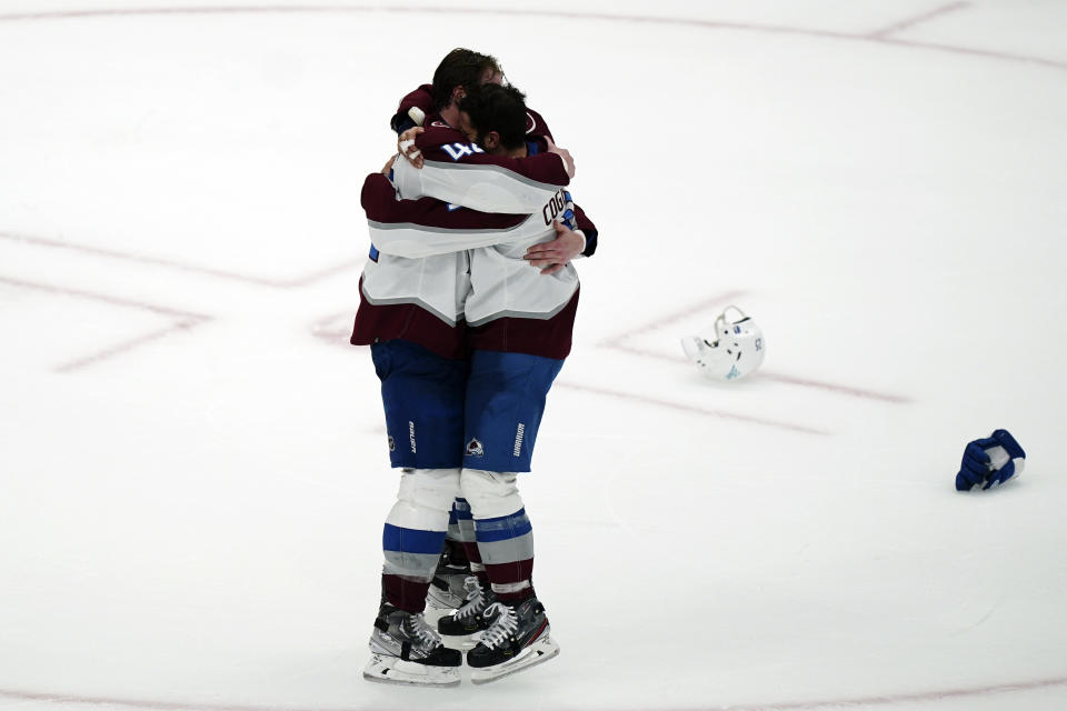 Colorado Avalanche defenseman Josh Manson (42), left, hugs center Andrew Cogliano (11) after the Avalanche defeated the Tampa Bay Lightning, 2-1 to win the NHL hockey Stanley Cup Finals on Sunday, June 26, 2022, in Tampa, Fla. (AP Photo/John Bazemore)