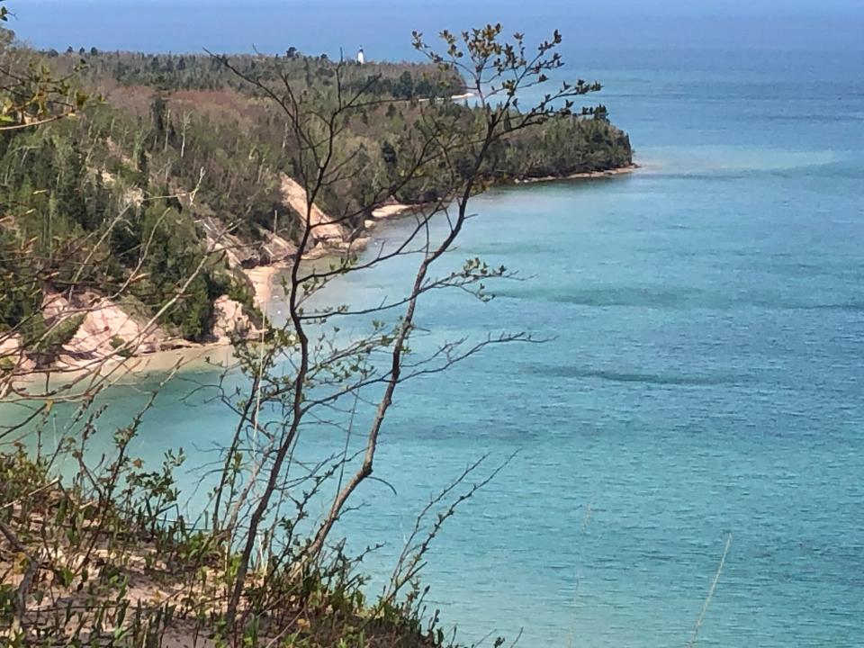 The Au Sable Light Station on the southern shore of Lake Superior in the Pictured Rocks National Lakeshore between Grand Marais and Munising, as seen from the North Country Trail on May 14, 2022.