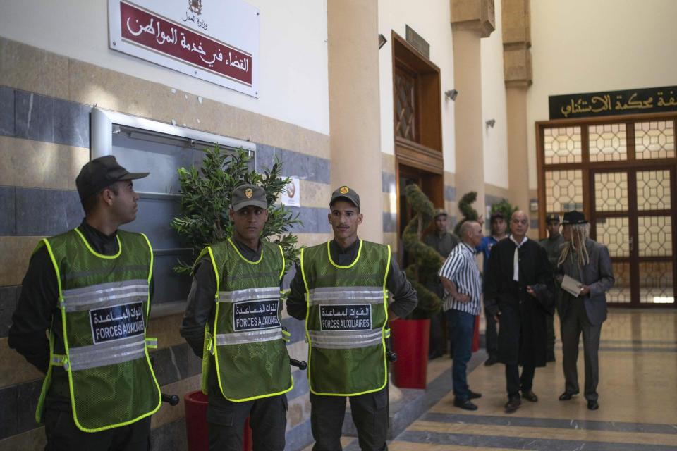 Security forces stand guard outside a court room before the start of a final trial session for suspects charged in connection with killing of two Scandinavian tourists in Morocco's Atlas Mountains, in Sale, near Rabat, Morocco, Thursday, July 18, 2019. The three main defendants in the brutal slaying of two female Scandinavian hikers have asked for forgiveness from Allah ahead of a verdict. (AP Photo/Mosa'ab Elshamy)