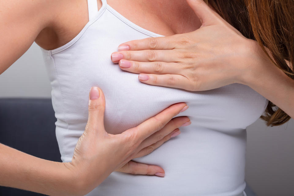 Close-up Of Woman's Hand Pressing Her Breast
