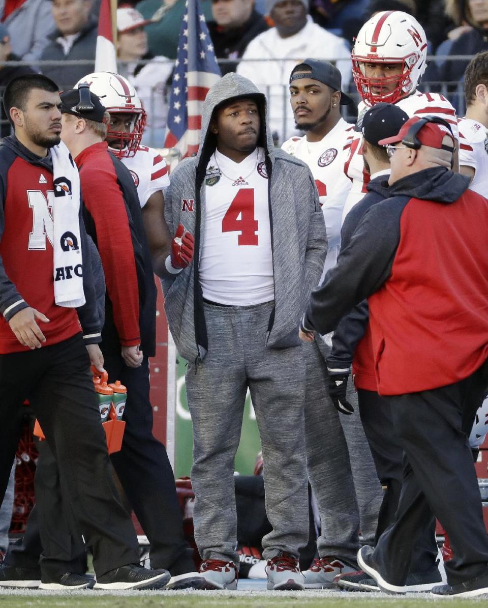 Injured Nebraska quarterback Tommy Armstrong Jr. (4) watches from the sideline in the first half of the Music City Bowl NCAA college football game against Tennessee, Friday, Dec. 30, 2016, in Nashville, Tenn. (AP Photo/Mark Humphrey)