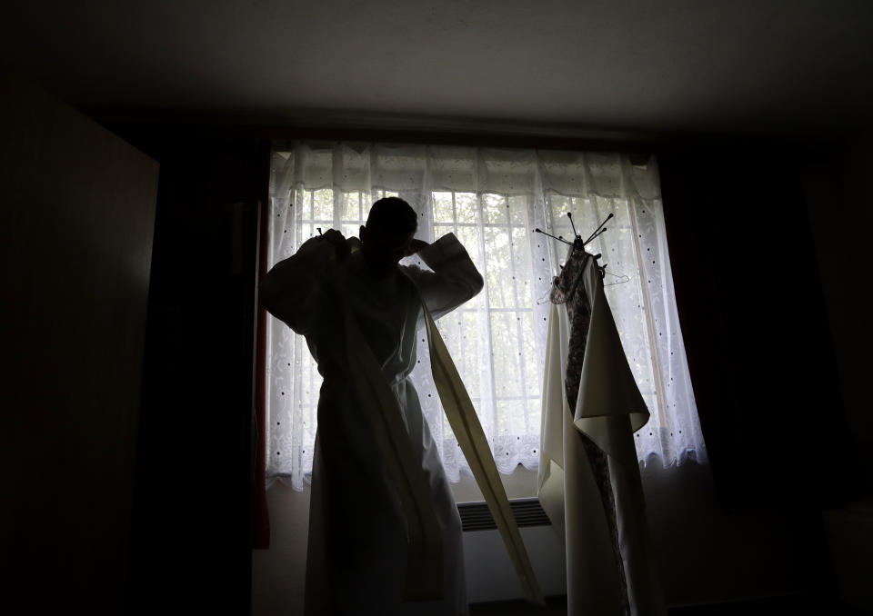 Roman Catholic priest Michal Lajcha dresses up a to serve a mass in a church in Klak, Slovakia, Monday, Sept. 17, 2018. Lajcha is challenging the Roman Catholic Church’s celibacy rules in a rare instance of dissent in the conservative religious stronghold in central and eastern Europe. (AP Photo/Petr David Josek)