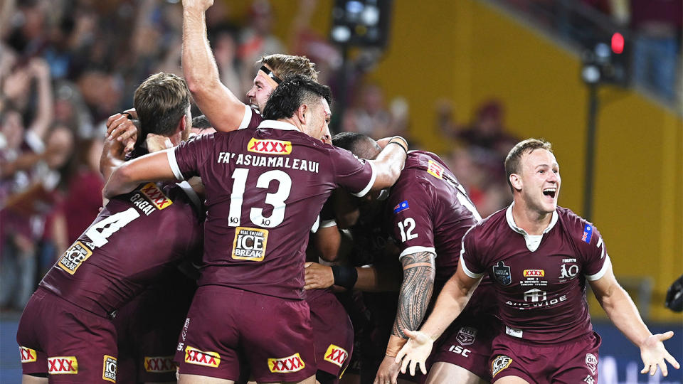 The Maroons celebrate after defeating the Blues during game three of the State of Origin series.