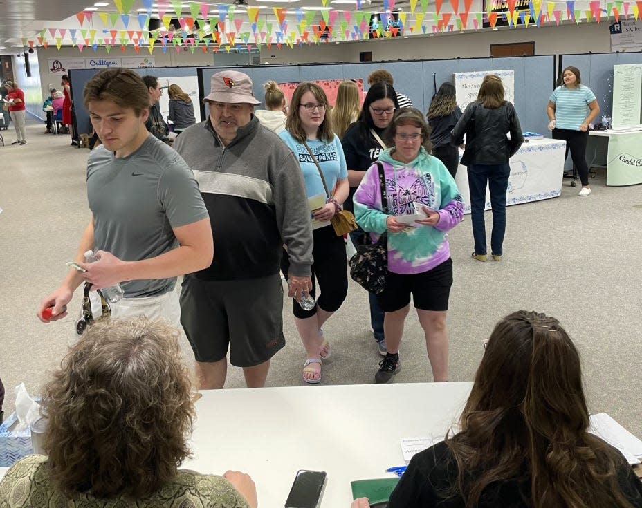 After shopping, customers lined up to pay for the goods and services they purchased at Mogul Palooza.