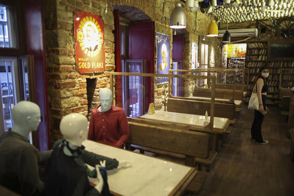 Mannequins that were used to be placed on tables to ensure social distancing to help curb the spread the coronavirus, are pictured in a restaurant in Istanbul, Thursday, July 1, 2021. Turkey's government on Thursday eased restrictions in place to curb the spread of the coronavirus, and have reopened theaters, cinemas and other entertainment centers. (AP Photo/Emrah Gurel)