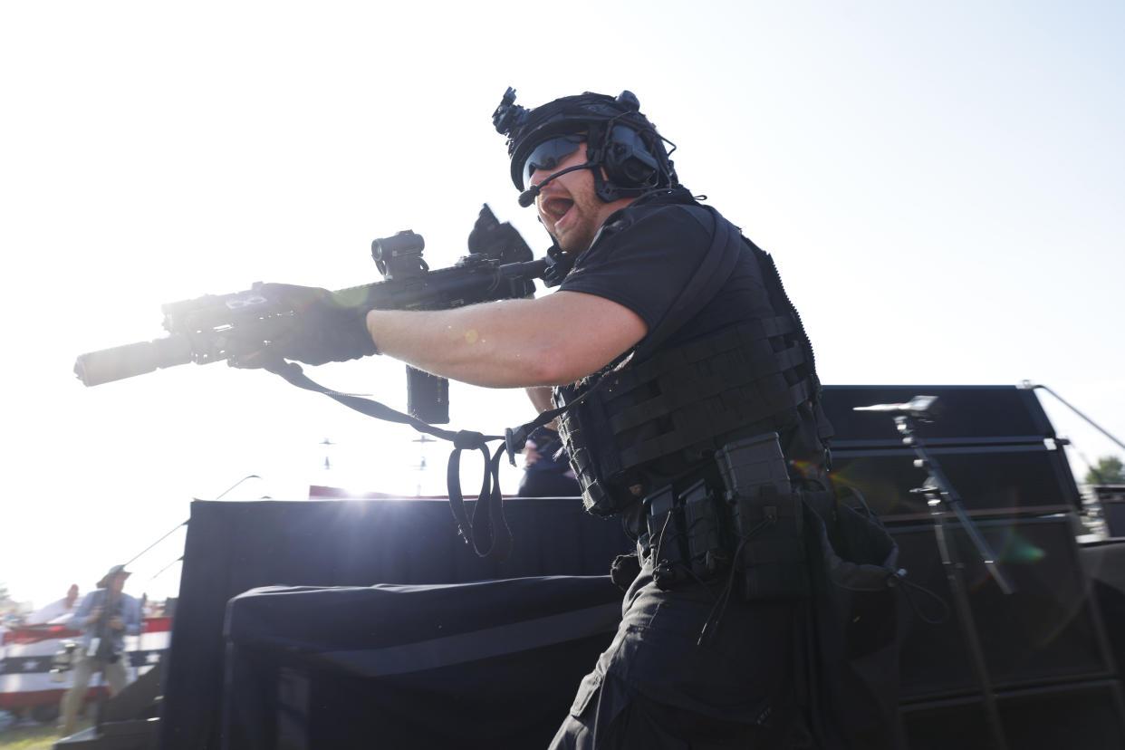 A law enforcement officer wields an automatic at Trump's rally in Butler, Pa.