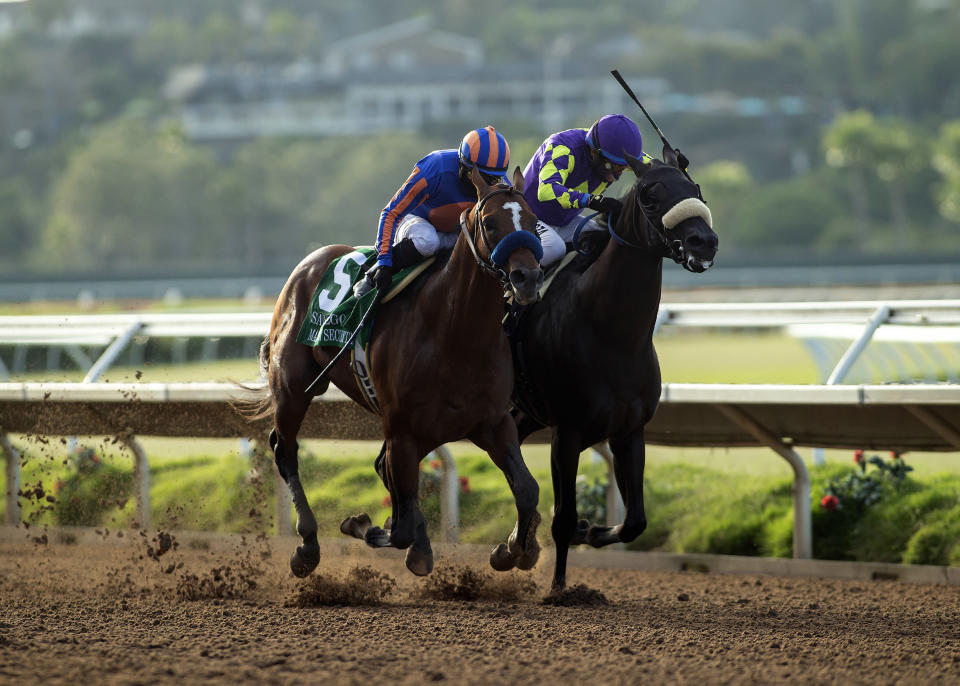 In this image provided by Benoit Photo, Maximum Security, left, with Abel Cedillo aboard, overpowers Midcourt, right, with Victor Espinoza aboard, to win the Grade II, $150,000 San Diego Handicap horse race Saturday, July 25, 2020, at Del Mar Thoroughbred Club in Del Mar, Calif. (Benoit Photo via AP)