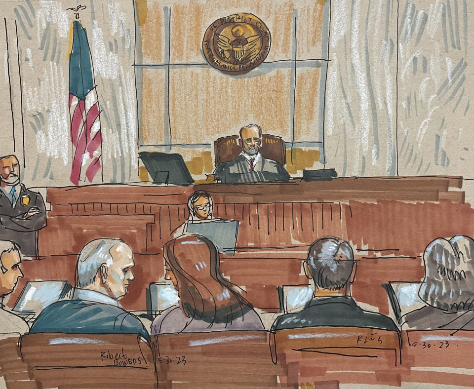 In this courtroom sketch, Robert Bowers, the suspect in the 2018 synagogue massacre, confers with his legal team on Tuesday, May 30, 2023, in Pittsburgh. Bowers could face the death penalty if convicted of some of the 63 counts he faces in the shootings, which claimed the lives of worshippers from three congregations who were sharing the building, Dor Hadash, New Light and Tree of Life. (David Klug via AP)