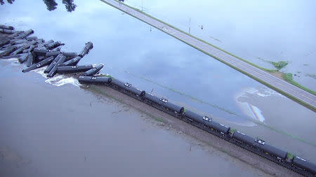 Tanker cars from a freight train carrying crude oil are shown after a derailment along the Rock River south of Doon, Iowa, U.S. in this June 22, 2018 handout still image taken from aerial drone video. Sioux County Sheriff's Office/Handout via REUTERS