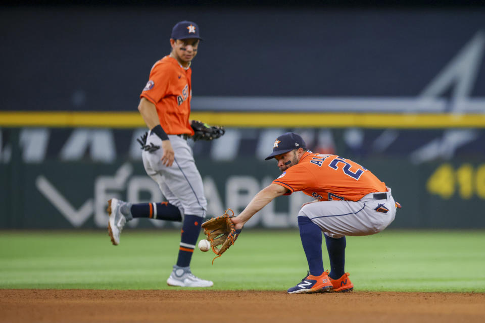 Houston Astros second baseman Jose Altuve, right, fields a ground ball as shortstop Mauricio Dubón covers in the fifth inning of a baseball game against the Texas Rangers, Sunday, July 2, 2023, in Arlington, Texas. (AP Photo/Gareth Patterson)
