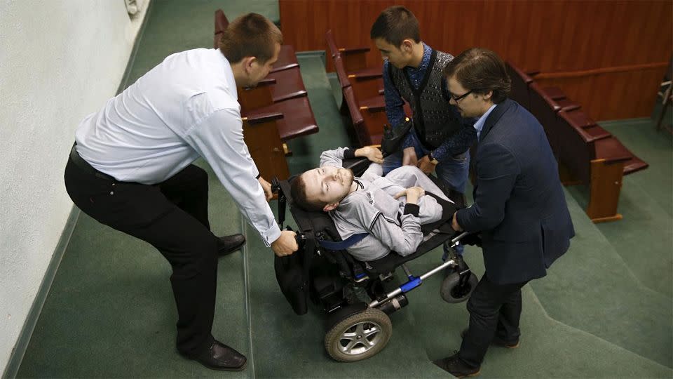 Valery Spiridonov (centre) suffers from Werdnig-Hoffman disease and has volunteered to be the first person to undergo a head transplant under Dr. Canavero's hands. Photo: Maxim Zmeyev/REUTERS