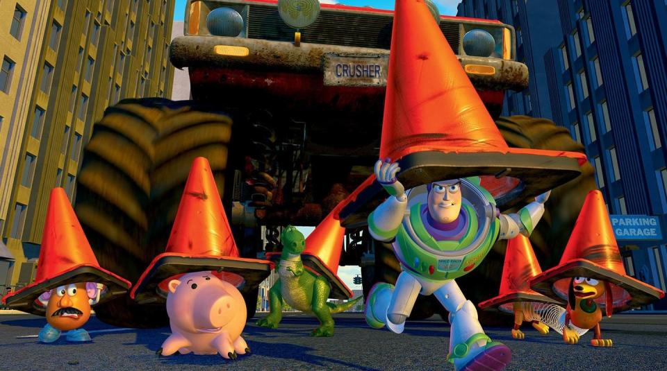 buzz, rex, slinky dog and other members of the toy story gang hide under traffic cones in a scene from toy story 2